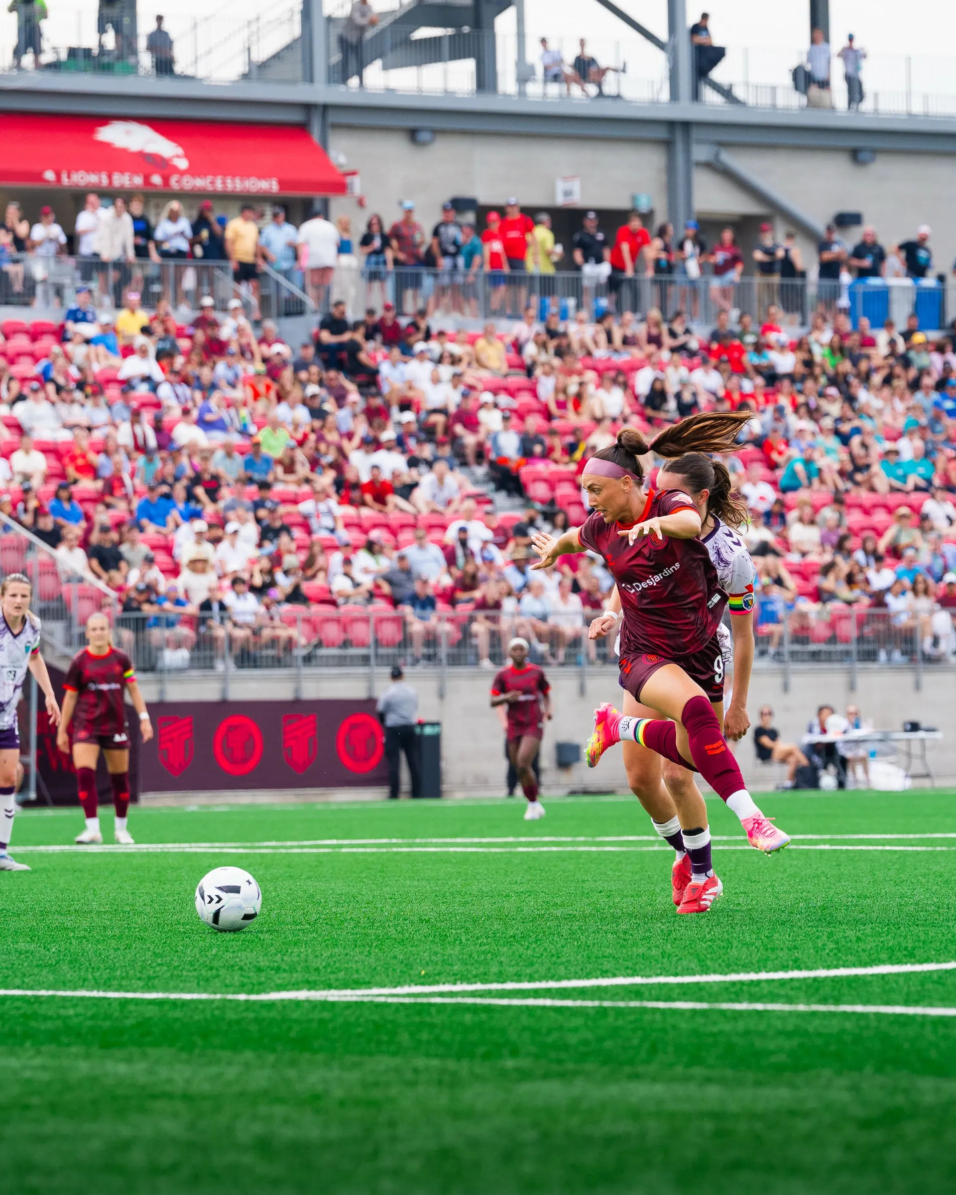 Jade playing for AFC Toronto in a packed stadium